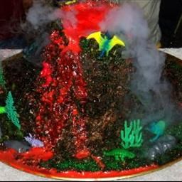 Erupting Volcano Cake on BigOven: Erupting Volcano Cake, Volcano Recipe, Volcano Party, Volcano Cake, Boy Cakes, Jurassic Park Birthday, Personalized Candy Bars, Erupting Volcano, Dinosaur Birthday Cakes