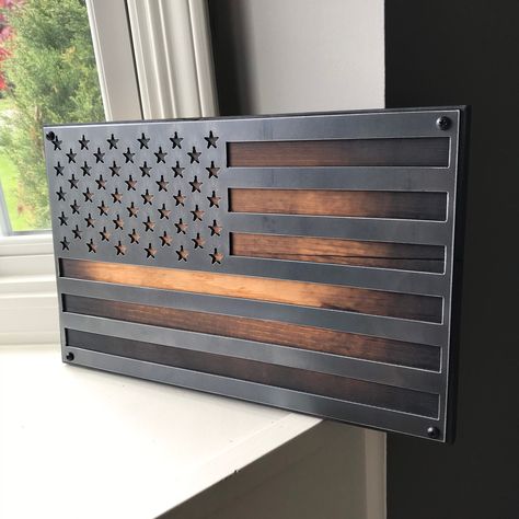 "What: American Flag Steel Wall Art Size: (4) available sizes:   - 16\"W x 10.5\" T   -24\" W x 15\" T   - 34\" W x 20.5\" T   - 40\" W x 23.5\" T Material: Reclaimed Barn Wood and 14 Gauge Steel   Hanging: Ready to hang. D-ring hooks on the back Handmade: Each piece is uniquely handmade. Slight variations in texture, color, characteristics of wood should be expected. All reclaimed barnwood is special and has a history all of its own. **The ultimate Father's Day gift** ** The Perfect Industrial Metal American Flag, American Flag Wall Decor, Industrial Signs, American Flag Wall Art, American Flag Art, Metal Flag, American Flag Wall, Steel Wall Art, Rustic American Flag