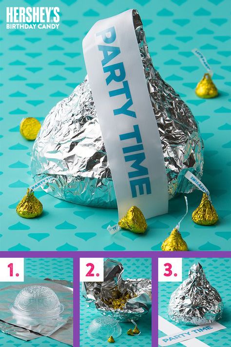 HOW TO MAKE A GIANT HERSHEY’S KISS party favor (FILLED WITH KISSES CHOCOLATES!)- A HERSHEY’S KISS shaped party favor filled with HERSHEY’S KISSES candy? Now that’s pretty KISS-ational! What you’ll need: colored HERSHEY’S Birthday KISSES candy, tin foil, plastic bowls, cardboard & printed KISSES flags. Click to get the step-by-step, birthdaytastic how-to. Let's make your child’s party the sweetest celebration ever, with HERSHEY’S Birthday candy. Let’s Birthday! Hershey Kisses Party Favors, Kiss Party, Hershey's Kisses, Candyland Party, Candy Party Favors, Candy Theme, Candy Crafts, Candy Land Theme, Birthday Candy