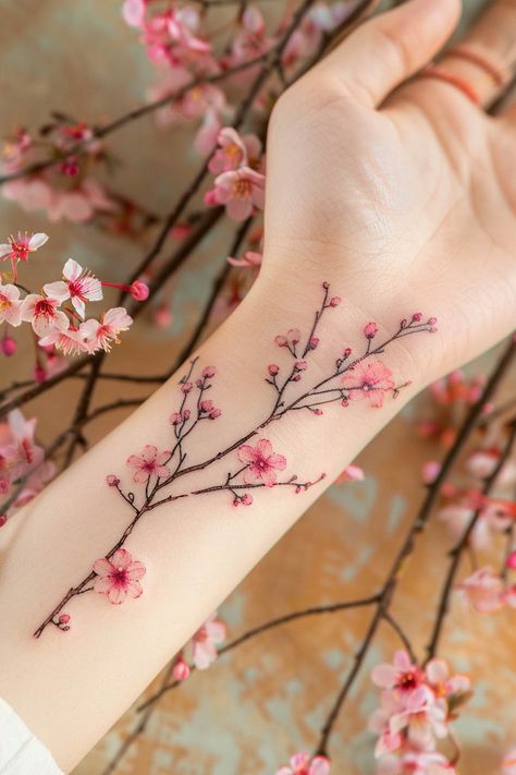 Explore 25 Flower Tattoo Ideas with Deep Meanings White Ink Floral Tattoo, Cute Cherry Blossom Tattoo, Women Tatoos Ideas With Meaning, Flowers Around Arm Tattoo, Flower Sleeves For Women Tattoo, Tattoo Ideas Cherry Blossoms, Dainty Cherry Blossom Tattoo, Flower Designs Tattoo, Cherry Blossom Sleeve Tattoo