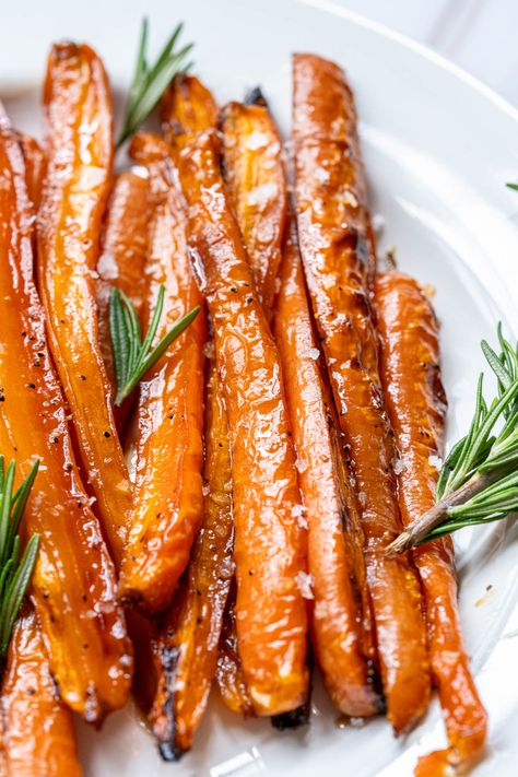 These sweet and tender Maple Glazed Carrots are the perfect easy recipe for the holidays or just a simple weeknight dinner. Roasted to perfection with a brown sugar and maple syrup buttery glaze, this side dish is always a family favorite! Paleo Glazed Carrots, Sheet Pan Glazed Carrots, Crock Pot Maple Glazed Carrots, Maple Dijon Carrots, Instapot Carrots Brown Sugar, Brown Sugar Maple Carrots, Glazed Roasted Carrots Recipe, Honey Maple Glazed Carrots, Maple Glaze Carrots