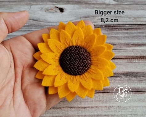 Beautiful sunny yellow Sunflower brooch pin is one of those classics you can wear in all seasons.  It is perfect to brighten your day. You can pin it on your coat, jacket, sweater, hat or a purse. Wear it on special occasion or gift it to your mom for mother's day Brooch is made out of best quality wool felt. ➤ Listing is for 1 brooch. Made from  European pure wool felt. Flower is made from 3 layers of yellow felt making it rich and 3-dimensional. Center is hand embroidered with weeing effect.   ➤ Size - options  - Bigger is about 8,2 cm ( 3 1/4 inch ), - Smaller is about 7 cm  ( 2 3/4 inch ). If you want to make the bigger brooch yourself, than check my shop PDF Fall section. Felt Making, Sunflower Brooch, Sunflower Jewelry, Sweater Hat, Jacket Sweater, Sunny Yellow, Felt Flower, Yellow Sunflower, Yellow Flower