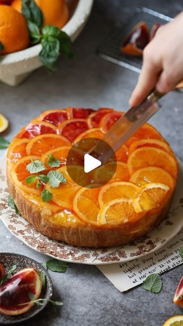 Betul Tunc on Instagram: "This colorful cake was one of the most tried and loved cakes of this year. For the perfect ombre effect, remember to layer the oranges so they completely cover the base without any gaps, and avoid slicing them too thinly. As 2023 draws to a close, I’d love to hear from you - how was your year?

Ombré Citrus Cake

Ingredients:
For the Bottom:
4 oranges (different varieties: orange, navel orange, blood orange)
1/3 cup granulated sugar
½ cup water
2 tbsp orange juice

For the Cake Batter:
3 eggs
1 cup/200g granulated sugar
¾ cup/165 ml peanut oil (or neutral oil)
¼ cup/60g yogurt
¼ cup/60g heavy cream
1 tsp vanilla or orange extract
2 tbsp orange juice
1 tbsp orange zest
1 ¼ cup/165g all-purpose flour
1 tsp/6g baking powder

For the Syrup:
Remai Citrus Cake, Colorful Cake, Orange Extract, Orange Syrup, Orange Blood, 3 Eggs, حلويات صحية, Peanut Oil, Orange Zest