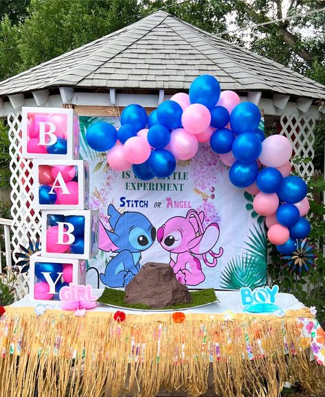 a stitch & angel themed banner is hung behind a table with a DIY volcano placed on top of it. there is a pink & blue balloon arch above the banner & on the sides of the volcano it says “boy, girl”. the table has a table skirt on it & there are boxes on the left side that say “baby”. Lilo Gender Reveal, Gender Reveal Ideas Anime, Gender Reveal Ideas Hawaiian, Gender Reveal Ideas Cartoon Theme, Gender Reveal Themes For Twins, Gender Reveal Ideas Cartoon, Stitch And Angel Decorations, Stitch Themed Gender Reveal Ideas, Cartoon Theme Gender Reveal