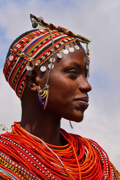 "We passed groups of Rendille heading to the market. These semi-nomadic tribal clansmen and women carried long spears, wearing brilliant red sashes decorated with silvery-coloured braids, ornaments and bangles. Tall and slender, they presented a picture-perfect image of a proud, self-assured independent people." Africa Overland; www.bradtguides.com Desert Dreamer, Afrique Art, Afrikaanse Kunst, African People, Maasai, African Culture, World Cultures, People Of The World, African Beauty