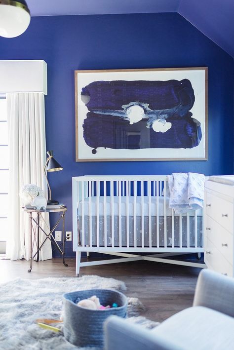 Baby Blues Nursery via MyDomaine. White modern crib, large scale blue abstract art, white changing table, hicks light pendant, sheepskin rug. Celebrity Nurseries, Baby Blue Nursery, Star Wars Nursery, Nursery Trends, White Crib, Stylish Nursery, Nursery Modern, Blue Nursery, Gender Neutral Nursery