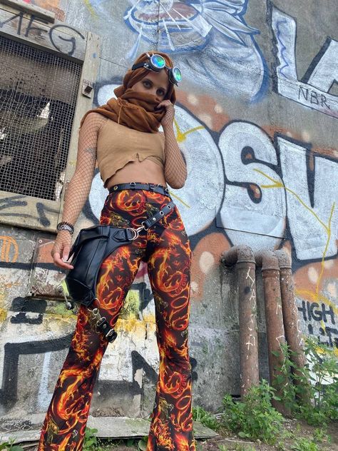 A girl is standing in front of a graffiti wall, wearing an outfit which is mad max inspired End Of The World Outfit, Psytrance Outfit, Psytrance Festival, Festival Fits, Rave Fits, The End Of The World, Rave Festival, Mad Max, End Of The World