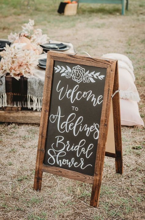 Greet wedding guests with a rustic wooden chalkboard sign welcoming them to your event. Click to see all the details of this fall bridal shower by party stylist Mint Event Design. #bridalshowers #bridalshowerideas #rusticwedding #rusticbridalshower #bridalshowerdecor #farmwedding #chalkboardsign September Bridal Shower Ideas, Fall Bridal Shower Ideas, Bridal Shower Chalkboard, Fall Bridal Shower Decorations, Wooden Chalkboard, Fall In Love Bridal Shower, Bohemian Bridal Shower, Shower Tips, Boho Bridal Shower