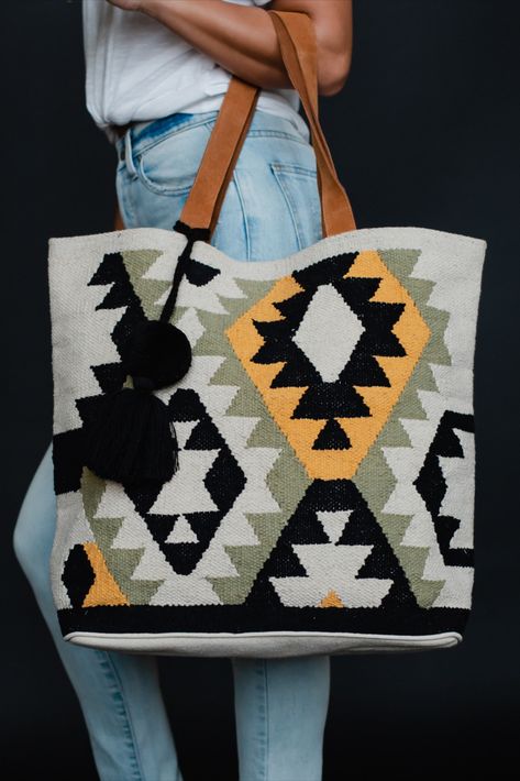 Our newest tote is a versatile and stylish bag, perfect for any spring occasion. With an Aztec inspired design, this tote features a pom tassel detail for added flair, and it makes the perfect weekender bag for all your essentials. Spring Tote, Knitted Hats Kids, Knit Hat For Men, Knit Jewelry, Kilim Bag, Summer Tote, Shoe Boutique, Knitting For Kids, Yellow And Black