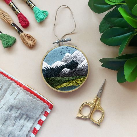 If you’ve seen me at a market over the past few weeks you know I have some new and reworked kits. Since my PNW pendant and pin kits were so beloved, I’ve also turned this design into an ornament!⁠ ⁠ It’s perfect for the coming holidays . You can make it as a treat for your tree or as a gift, or give it to your crafty Seattle loving friend! #pnw #embroidery #ornament #seattle #mountainlover #landscapeart #mcreativej Pnw Mountains, Wood Embroidery, Diy Beginner, Needlecraft Kits, December Crafts, Beginner Embroidery, Ornament Craft, Everyday Decor, Ornament Diy