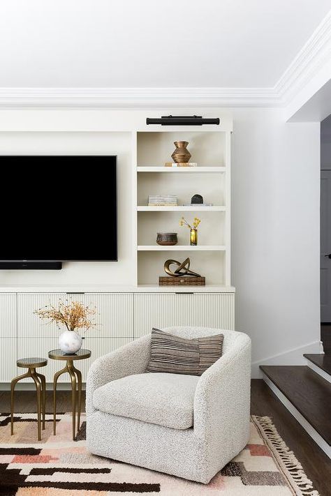 Chair Under Tv, Grey Jute Rug, Boucle Swivel Chair, Pale Pink Wallpaper, Light Gray Couch, Wall Mount Tv, Curved Couch, Fringe Rug, Pink Velvet Pillow