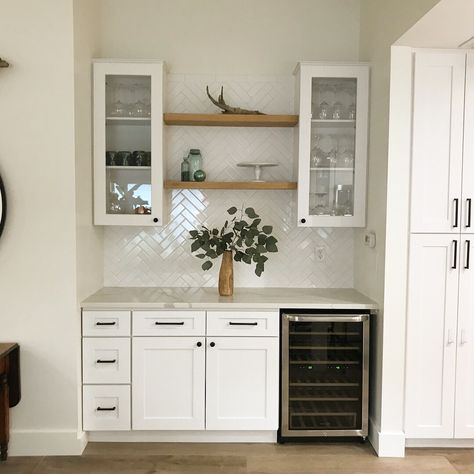 White Oak floating shelves. #whiteoak #floatingshelves #goldandwhite #whitebacksplash #whitecabinets #minimilistdecor #homedecor Floating Shelves Bar Area Kitchen, Backsplash For Bar Area, Bar Area Backsplash, Beach House Wet Bar, Bar Area With Floating Shelves, Floating Shelves Bar Area, Herringbone Backsplash White, Coffee Bar Backsplash, Wet Bar With Floating Shelves