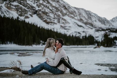 Woman sitting on her fiancé’s lap facing him kissing Sitting On Lap Facing Each Other, Frozen Waterfall, Snow Covered Mountains, Dog Snow, Couple Stuff, Man Photography, Photography Company, Pose References, Woman Sitting