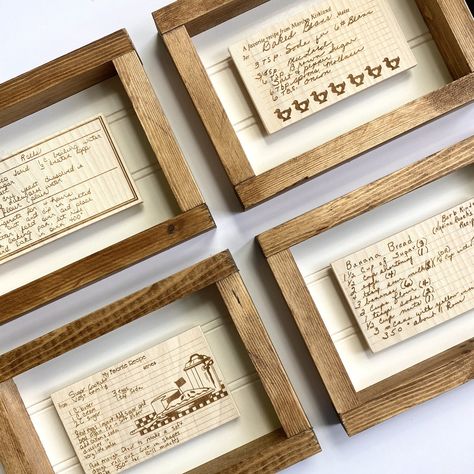 "A beautiful framed option for your custom wood recipe cards! Our new frames are sized to hold your 3\"x5\" or 5\"x7\" wood recipe cards to be able to display beautifully in your kitchen. Each frame has a metal strip in the center, and each card has two magnets on the back to be able to attach and interchange easily with multiple cards. Now you can change up your recipes for each party or season! Find your beautifully handwritten recipe cards and we'll etch them onto wood for the perfect keepsak Old Recipe Display Ideas Diy, Framed Recipes In Kitchen Display, Family Recipe Display, Recipe Gifts Handwritten, Framed Recipe Cards, Handwritten Recipes Display, Recipe Keepsake Ideas, Framing Recipes, Framed Recipes In Kitchen