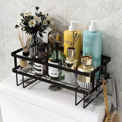 The main feature of this bathroom is a no-drill over-the-toilet storage shelf that holds various items. Image credit: INSTAGRAM @DIAMOND_TRENDYHOMES Bathroom Organization Shelves, Toilet Rack, Over Toilet Storage, Shelves Over Toilet, Over The Toilet Storage, Bathroom Shelves Over Toilet, Toilet Shelves, Over The Toilet, Small Bathroom Organization