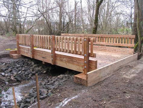 Timber Bridges Division | Vehicular & Pedestrian Bridges | Boardwalks | Western Wood Structures | Tualatin, OR Backyard Creek, Mountain Landscaping, Yard Bridge, Timber Bridge, Garden Bridge Design, Outdoor Bridges, Bridge Ideas, Forest Ideas, Creek Bridge