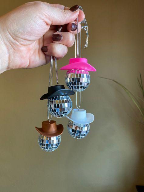 "PLEASE READ ITEM DESCRIPTION AND VIEW ALL LISTING PICTURES! MORE mini cowboy hat accessories available here in my Etsy store: https://www.etsy.com/shop/aMAYSEingDesignCo These mini disco balls with a cowboy hat on top are adorable! Perfect for hanging in your rear view mirror. When the sun hits them it is like a disco party in your car. They make great Christmas ornaments too! Choose your favorite color cowboy hat pink, black, white, or brown AND the color of the hanging cord silver or black. I Cowboy Hat Disco Ball, Mini Disco Balls, Nashville Cowgirl, Disco Ball Hanging, Disco Cowboy, Mini Cowboy Hat, Mini Cowboy, Cowboy Room, Mirror Hanging