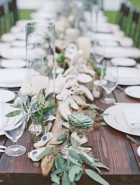 succulents, driftwood, seeded eucalyptus and oyster garland make a perfect coastal feel Oyster Table Decor, Seaglass Tablescape, Oyster Table Setting, Oyster Shell Table Decor, Driftwood Table Decor, Simple Beach Wedding Table Decor, Driftwood Centerpiece Wedding, Oyster Wedding Decor, Driftwood Wedding Centerpieces