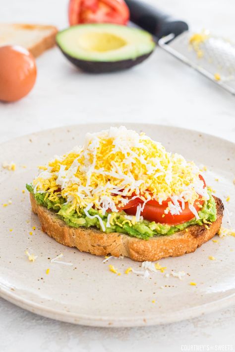 Grated Avocado Toast is a complete breakfast and oh so good. Hard boiled egg grated over the top of mashed avocado and slices of fresh tomato. Viral TikTok recipe! Egg Avocado Toast, Luncheon Recipes, Complete Breakfast, Egg Avocado, Avocado Toast Egg, Hard Boiled Egg, Avocado Toast Recipe, Avocado Breakfast, Fresh Avocado