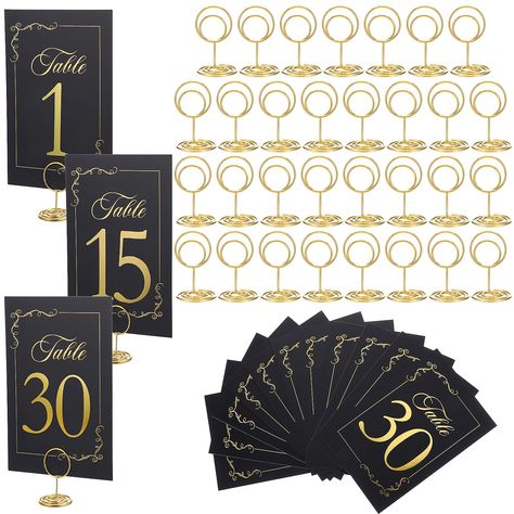 PRICES MAY VARY. Delicate and Beautiful: These table number holders don't feel flimsy. The size is large enough and the numbers on the table numbers are clearly visible, but not so large that they take up space on the table. In addition, the gold on black adds a touch of elegance to your table. Suitable for weddings or banquets. Wide Range of Uses: The black and gold color of the table number holder stands out on the table, and the cards are sturdy and large enough for guests to quickly find the Black And Gold Centerpieces Birthday, Black And Gold Table Decorations, Black And Gold Centerpieces, Black And Gold Party Decorations, Table Number Holder, Table Number Stands, Gold Centerpieces, Table Number Holders, Gold Party Decorations