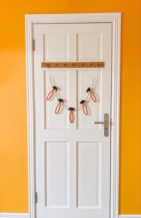 Easter Carrot Garland hanging on the back of a door Bunny Macrame, Macrame Duck, Macrame Carrot, Rabbit Macrame, Easter Macrame, Llama Macrame, Carrot Garland, Galway Ireland, Beads Handmade