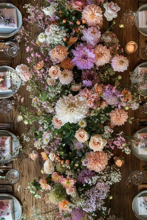 Lush bouquet of pink, peach, and purple flowers arranged on a wooden table. Unleash your inner florist with wild and whimsical floral wedding ideas that will make your special day bloom like never before. Purple And Pink Flower Arrangements, Purple And Peach Wedding, Whimsical Flower Arrangements, Whimsical Floral Wedding, Floral Wedding Decor, Floral Wedding Ideas, Pink Flower Arrangements, Floral Wedding Cake, Floral Wedding Decorations