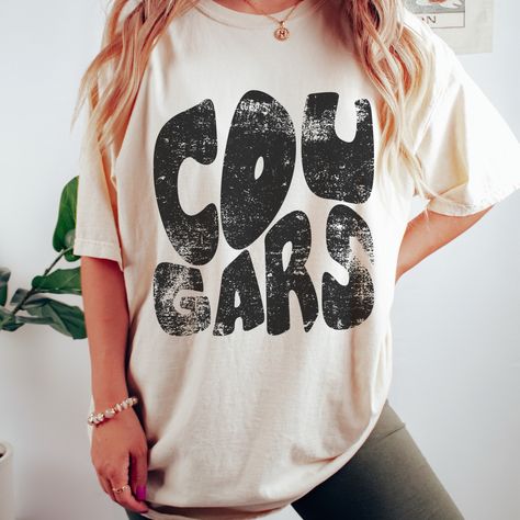 Here's a tee made just for you and your team spirit! This distressed Cougars Mascot tee is super soft and comfy. Shown on a super soft comfort colors ivory tee, but so many colors to choose from. Design made on unisex comfort colors shirt. Bobcat Spirit Shirts, Cricut Clothing, Cheer Gear, Mascot Shirt, School Spirit Wear, Distressed Shirt, Spirit Shirts, Comfort Colors Shirt, Spirit Wear