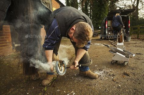 A farrier shoeing a horse, bending down and fitting a new horseshoe to a horse's hoof. by Mint_Images. A farrier shoeing a horse, bending down and fitting a new horseshoe to a horseâ€™s hoof. #Sponsored #horse, #bending, #farrier, #shoeing Gold Bars, Coins For Sale, Gold Bar, A Horse, Bending, Bend, Horses, Mint, Gold