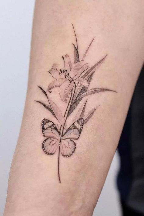 The Meanings Of Lily Tattoos: An Extensive Explanation Butterfly And Lily Tattoo, Lily And Butterfly Tattoo, Small Lily Tattoo, Lilly Flower Tattoo, Lily Tattoo Meaning, Lily Tattoos, Butterfly With Flowers Tattoo, Butterfly Tattoo Stencil, Lillies Tattoo