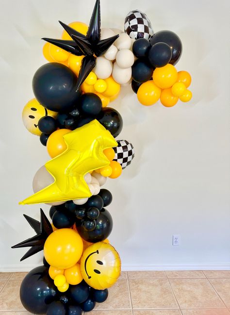 Make your party a hit with our One Cool Dude Groovy Party decorations! This Happy Dude Balloon Garland includes smiley bolt and checked balloons, adding a playful touch to your celebration. Get ready for a blast from the past with this retro-inspired decor This DIY Latex Balloon Garland Kit Includes: A Mix if 11" (Black, Golden Rod, White Sand ) A Mix of 5" (Same as above) Smile, Bolt, Black Starbursts and Checker Balloons included included   Balloon Garland Strip in desired size  (1) Handheld Balloon Pump (option without hand pump)   Strip of Sticky Glue Tabs  (DIY Directions are also included with this purchase)  Each Kit includes calculated amount for size of ordered Garland. This Balloons Garland can be inflated 2-4 days in advance, will take approximately 2-3 Hours from start to finis One Happy Dude Balloons, One Smiley Dude Birthday, Five Is A Vibe Birthday Party Boy, Checkered Birthday Theme, Cool Dude Birthday Party, Groovy Party Decorations, One Happy Dude First Birthday, Dude Birthday Party, Emo Party