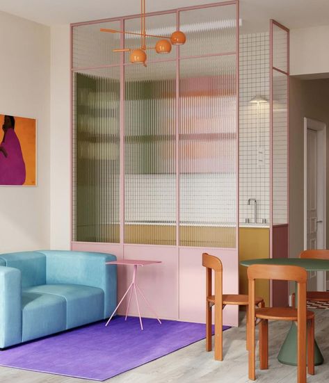 Small, colorful apartment in Berlin. On the kitchen side, cabinet doors are made of natural wood, while others are painted pastel pink and green. On the wall, small square white ceramic tiles. The living room features an orange pendant light, a pastel-blue sofa, a purple rug and a small pink table. Between the two, to divide the spaces, a glazed wall with pink frames and flutex glass. Polish Interior, Inside Window, Spiritual Wall Decor, Berlin Apartment, Colourful Home, Colour Set, Deco Studio, Glass Partition, Room Partition