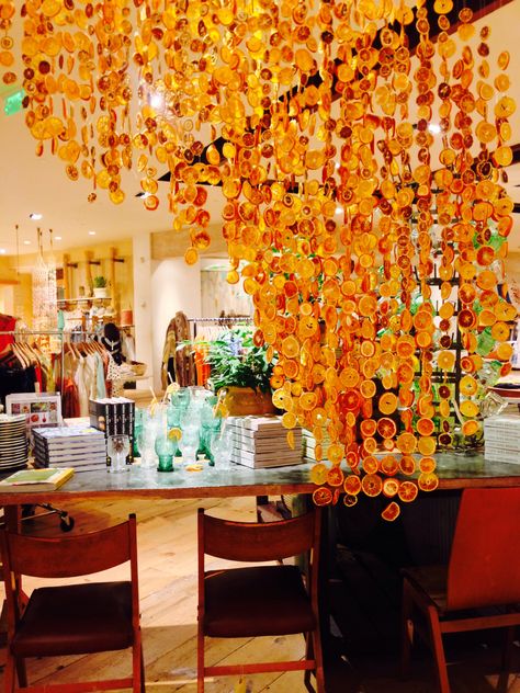 It's dried out lemons and oranges. Made anthropologie smell really good! Dried Citrus Curtain, Dried Orange Chandelier, Dried Orange Backdrop, Dried Citrus Wedding Decor, Dried Oranges Wedding Decor, Citrus Display, Dried Fruit Decor, Reception Ceiling, Anthropologie Decor