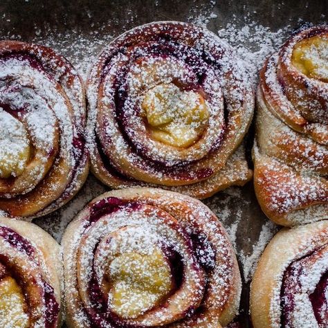 Nevada Berg on Instagram: "One of the most popular recipes I’ve shared to date are these Raspberry Custard Buns (Bringebærsnurrer med vaniljekrem), and for good reason! Sweet and tart raspberries and bright yellow custard are wrapped in a blanket of cardamom dough for a delicious pastry that’s not difficult to make. As the buns bake, the flavors seeps into one another in the most delightful way. Finishing them off with a dusting of powdered sugar and enjoying them while still warm is the best way to savor each one. Make these to bring a little more sunshine to your day, recipe on my site! ✨" Raspberry Custard Buns, Cardamom Custard, Raspberry Custard, Custard Buns, Wrapped In A Blanket, Baking Buns, Summer Sweets, Most Popular Recipes, Popular Recipes