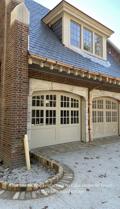 Arch Garage Doors House, Garage Conversion Front Of House, Tudor Carriage House, Arch Garage Doors, 50s Ranch House Exterior, Garage Door Awning, Detached Garage With Breezeway, Tudor Garage, Brick Carriage House