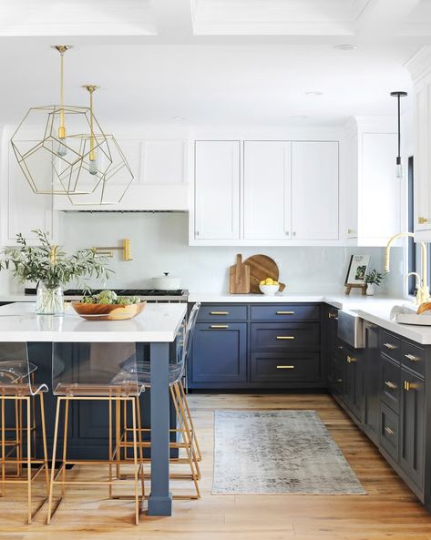 kitchen with dark lower cabinets and bright upper cabinets wood floors, brass fixtures, pendant lamps from arteriors pacific palisades home of interior designer heather lucas Navy Blue Accent Kitchen, Blue Kitchen Lower Cabinets, Dark Lower Kitchen Cabinets, Navy Lower Cabinets White Upper, Kitchen Ideas Blue Cabinets, Wood And Blue Kitchen, Navy And Wood Kitchen, Blue Cabinets With Gold Hardware, White Kitchen Blue Island