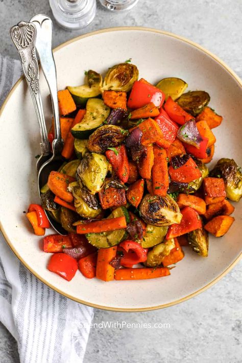 Oven-roasted vegetables are perfect for feeding a crowd. Budget-friendly, hearty, and using veggies that are available year-round, this dish is definitely a winner! Want to stretch it even further? Try serving over rice or quinoa! Bright & colorful veggies are tossed in a balsamic-honey glaze, then roasted until perfectly crispy. We love serving these oven-roasted vegetables with chicken, pork, or beef entrèes! #roastedvegetables #roastedveggies #ovenroastedvegetables #spendwithpennies Roasted Vegetables With Chicken, Roasted Carrots And Parsnips, Colorful Veggies, Hearty Vegetable Soup, Roasted Vegetables Oven, Spend With Pennies, Root Veggies, Recipe Simple, Honey Glaze