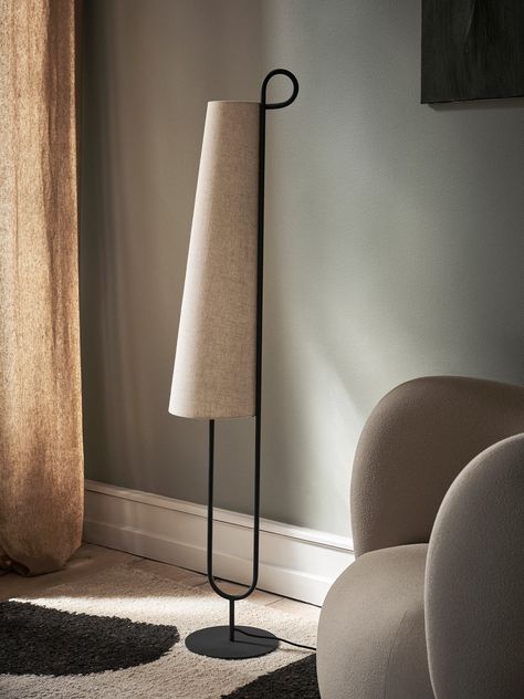 The Ancora Floor Lamp derives its name from the Italian word for 'anchor,' drawing inspiration from its distinctive shape. The warm and textured textile lampshade beautifully contrasts its powder-coated iron base, resulting in a poetic and vintage-inspired expression. This design effortlessly balances lightness and materiality, creating an enchanting ambiance in any space.Product Overview Color: Black/Natural Dimensions: 9.8"W x 9.8"D x 59.1"H Material: Powder coated iron structure. 2 x E26 sock Italian Word, Living Modern, Italian Words, Fabric Lampshade, Black Floor Lamp, Luminaire Design, Can Lights, Burke Decor, Ferm Living