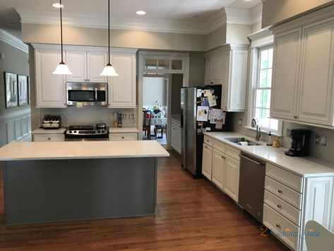 Our homeowner was ready for a major kitchen overhaul. No more traditional cabinets, backsplash and counters. Her vision for lightening things up? White cabinets, white counters, and a soft gray backsplash. We helped her achieve her vision by painting the perimeter cabinets with Benjamin Moore Cloud Cover. It’s a soft white with gray undertones. The … Cloud Cover Benjamin Moore Cabinets, Cloud Cover Benjamin Moore, Benjamin Moore Kitchen, Gray Backsplash, Cabinet Island, Kitchen Island Cabinets, Grey Backsplash, White Counters, Cabinets White