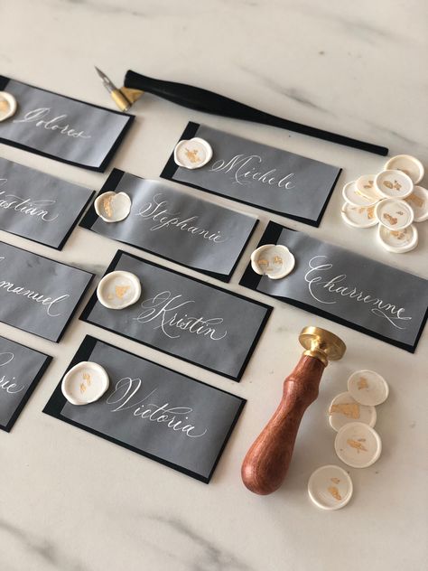 White ink on black paper
Calligraphy name tags 
White wax seals gold foil/leaf Calligraphy Name Tags, Ink Calligraphy, Calligraphy Name, White Wax, Touch Of Gold, Name Cards, Name Tags, Wax Seals, White Ink