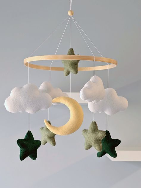 Green Stars and Moon Personalized Baby Mobile  Featuring soft white clouds, charming stars in sage and dark green, and a pale yellow crescent moon, this mobile is perfect for lulling your little one to sleep. It's perfect for nursery decor, baby showers, and as a thoughtful gift for new parents One of the clouds can be personalized. If you would like to add the baby's name on it, please indicate it in the section for personalization. ✳️ Baby mobile Includes 1 moon 2 Dark Green stars 3 Sage stars Neutral And Green Nursery, Dark Green Baby Nursery, Dark Green Nursery Boy, Nursery Inspo Gender Neutral, Gender Neutral Nursery Green, Nursery Ideas Green, Green Nursery Neutral, Dark Green Nursery, Baby Room Ideas Neutral