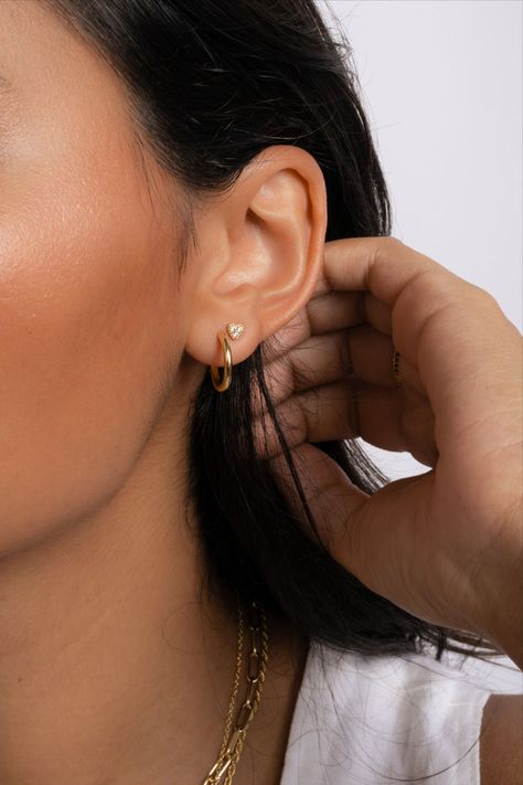 Model wearing simple earring stack of gold huggies and dainty heart studs. Dainty Earring Stack, Simple Gold Hoop Earrings, Earring Stack, Earrings Aesthetic, Tiny Studs, Tiny Heart, Affordable Jewelry, Dainty Earrings, Minimalist Earrings