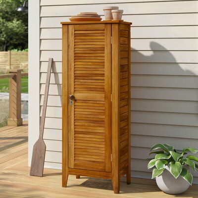 This storage cabinet is made from solid acacia wood that's naturally water- and UV-resistant, so you can use it outside to store pool toys or garden essentials. Slats on all three sides and louvre paneling on the door give this cabinet a breezy coastal farmhouse look. The door opens to reveal three removable and adjustable shelves, allowing maximum flexibility in storage. With the shelves, removed items like shovels and brooms can be stored. Plus, this storage cabinet can be locked for additiona Outdoor Cabinets Patio Storage Cabinets, Deck Storage Cabinet, Small Outdoor Storage Cabinet, Patio Storage Cabinet Wood, Outdoor Storage Cabinet Waterproof, Pool Towel Storage, Teak Bathroom Storage Cabinet, Outdoor Barbeque, Outdoor Storage Cabinet