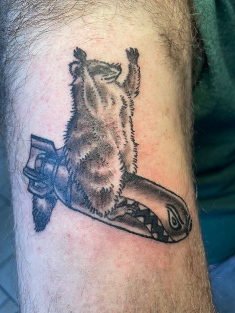 Tattoo of a raccoon , on a bomb 4arm Tattoo Men, Tactical Raccoon Tattoo, Funny Western Tattoos, Cowboy Raccoon Tattoo, Matching Raccoon Tattoo, Trash Panda Tattoo, Traditional Raccoon Tattoo, Raccoon Tattoo Funny, Small Raccoon Tattoo