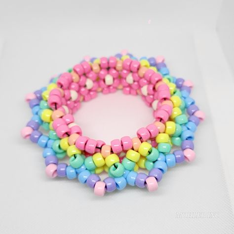 This gorgeous, one of a kind kandi mandala cuff will be the envy of all your friends! With its pastel-hued perfection, your look will be truly out of this world! 🌈 *Length is 30 pony beads or 10.6 in around Pony Beads Bracelet Patterns, Kuromi Kandi Cuff, Big Kandi Cuff, Kandi Inspo Single, Kandi Inspo Cuff, Kandi Bracelets Ideas Cuffs, Kandi Ideas Cuffs, Pastel Kandi, Kandi Patterns Cuff