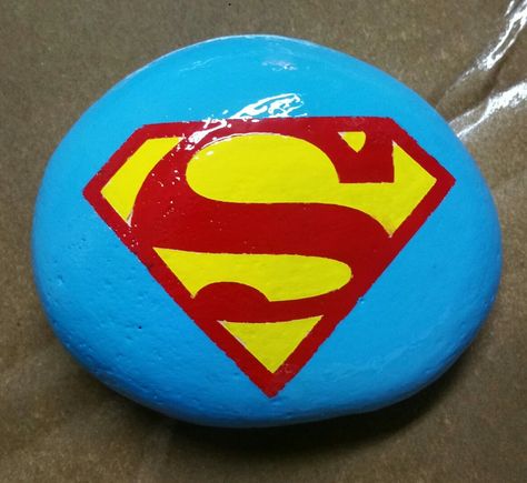 Superman painted rock Superman Rock Painting, Superhero Rock Painting Ideas, Painted Garden Rocks, Film Characters, Garden Rocks, Paint Rocks, Diy Rock Art, Sidewalk Chalk Art, Rock Painting Ideas