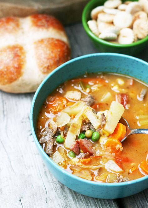 Booyah stew: An Upper Midwestern classic! Learn how to make this hearty meat and vegetable stew at home. Booyah Recipe, Expensive Steak, Sausage Stew, Cycle Syncing, Oyster Crackers, Soup Broth, Chicken Base, Vegetable Stew, Coleslaw Mix