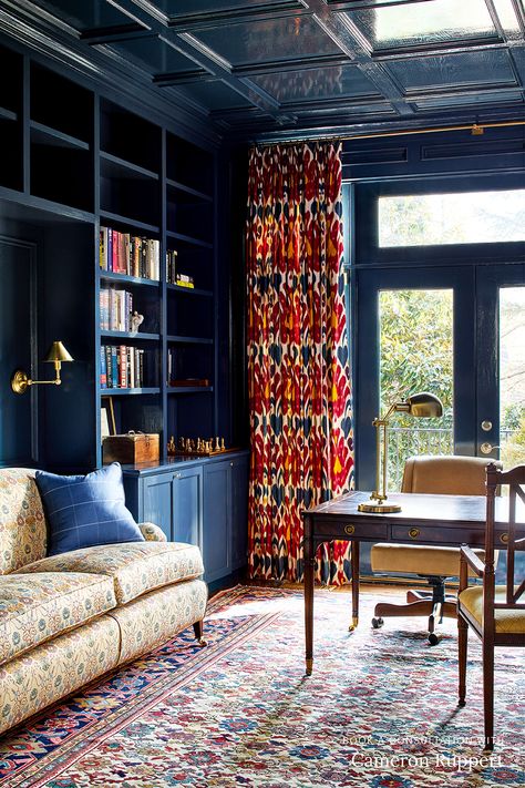 This traditional home office by DC-based interior designer Cameron Ruppert features navy lacquered walls (with matching ceiling), built-in bookcases in the same finish, red Ikat curtains, a yellow printed roll-arm sofa, and a vintage rug. Like what you see? Book a 1:1 video consultation with Cameron Ruppert on The Expert and get personalized interior design advice for your space. Ikat Curtains, Floor Plan Layout, White Office, Pierre Frey, Ergonomic Chair, The Expert, Home Library, Built In Storage, Built Ins