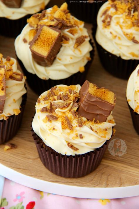 Chocolate Cupcakes, Honey Buttercream Frosting, and Cadbury’s Crunchie Bars… Hello Honeycomb Crunchie Cupcakes! Hi, I’m Jane, and I have an addiction to Crunchies. Like seriously, they’re in EVERYTHING that I bake at the moment, and I just can’t help using them again and again. Weirdly, I never used to like them so much, but after making my Honeycomb Crunchie Fudge recently, and making my No-Bake Honeycomb Crunchie Cheesecake over and over again, I really do think I have a slight problem! Wel... Crunchie Cupcakes, Honey Buttercream Frosting, Chocolate And Orange Tart, Honey Buttercream, Crunchie Bar, Janes Patisserie, Novelty Birthday Cakes, Fairy Cakes, Halloween 2023