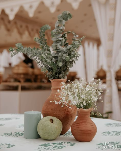 Experience the magic of our Mehendi soirée, blending Rajasthani fort allure with bohemian rustic flair. Amidst lush greens and ivory accents, earthen vessels cradle delicate baby’s breath. Lounge under billowing drapes on elegant ivory chairs, surrounded by rustic cane basket hangings. Each detail whispers a tale, each moment a cherished memory. Decor & Design: @design__hq Choreography: @happydancingfeet100 Venue: @suryagarh Photos: @playthenovel [WedmeGood, WeddingSutra, Botanical, Mehend... Minimalist Indian Wedding Decor, White And Green Indian Wedding Decor, White And Green Wedding Decor Indian, Earthy Indian Wedding Decor, Sustainable Indian Wedding Decor, Intimate South Indian Wedding Decor, Memory Decor, Rajasthani Fort, Earthen Vessels