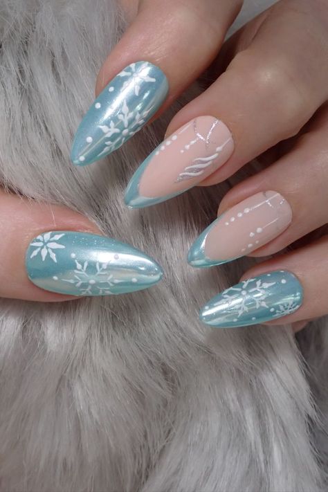 New nail inspo to create pretty Christmas Nails at home with gel nail polish. This nail design was created with lagoon blue gel nail polish, moonlight mirror powder (yes the same stuff used to create donut nails! 😝), silver and white gel paint for the cute snowflakes nail art ❄️ as well as two liner nail art brushes for the french tips and the Christmas decorations nail designs. Watch my tuto at Nail Art Bay! #Christmasnails #frozen #nailart #naildesigns #gelnails #nailsathome Almond Christmas Nails, Christmas Nail Design, Blue Mirror, Silver Christmas, Icy Blue, Christmas Nail, Christmas Nails, Nail Design, Almond